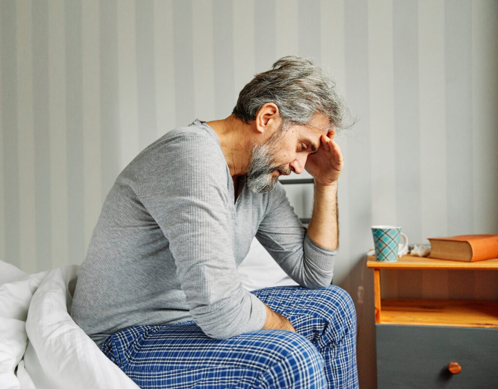 senior bed man problem pain headache home elderly mature pain bedroom unhappy female adult relationship retirement old difficulty ache head sick migraine hangover sleep stomach stomachache diarrhea